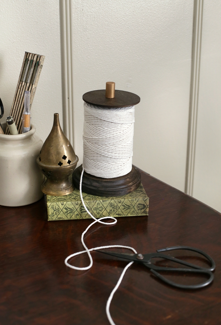 twine unraveling from holder next to black gardening shears