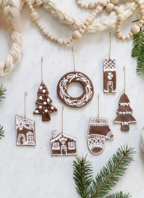 gingerbread ornaments with gold hooks on white backdrop