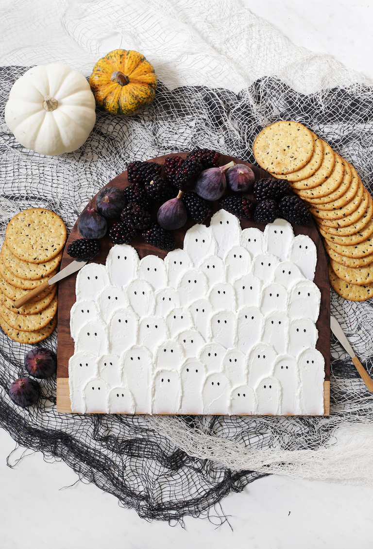 halloween cheese board with fruit and surrounded by crackers
