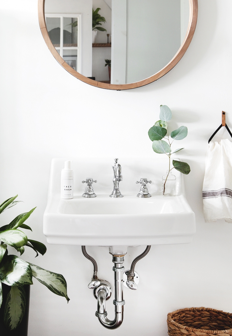 bathroom sink with green stem on it 