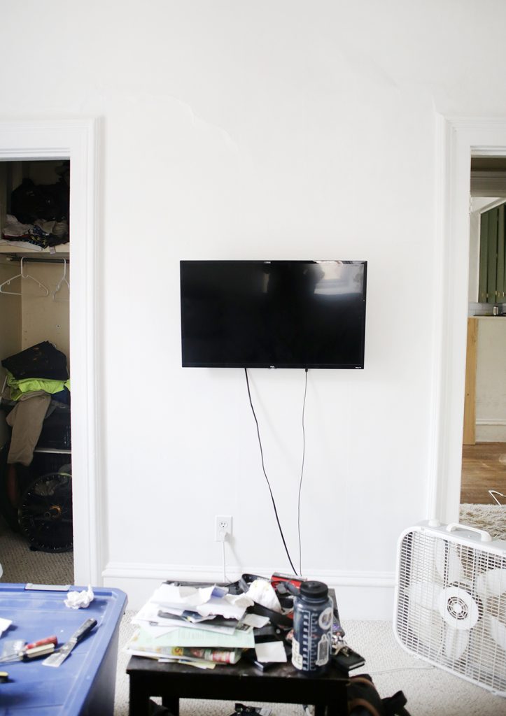 tv hanging on white wall