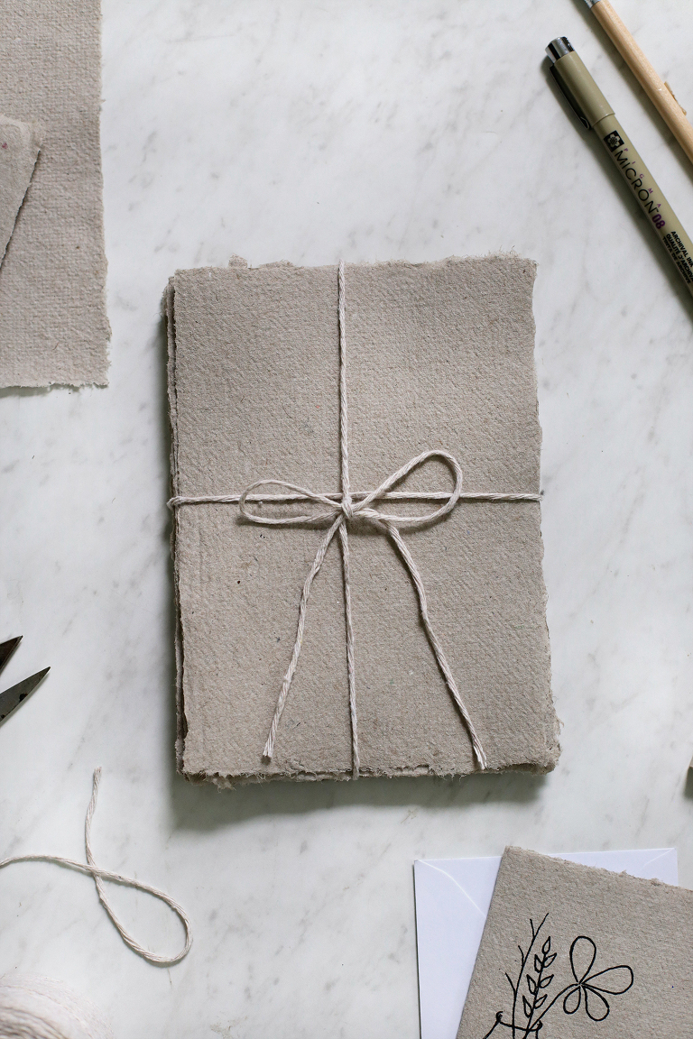 overhead shot of recycled paper tied up with string