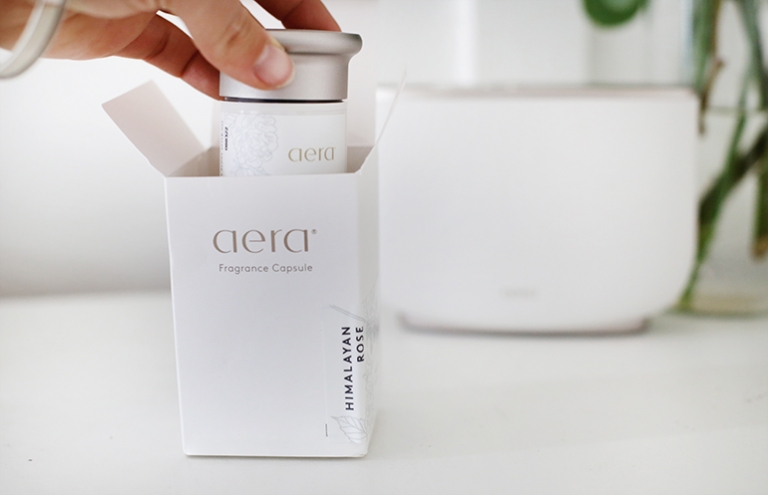 aera fragrance capsule being pulled out of a box