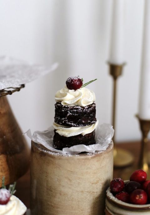 single mini brownie cake topped with cranberry and rosemary