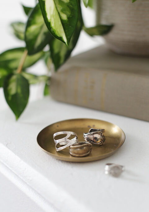 three spoon rings on a brass tray 