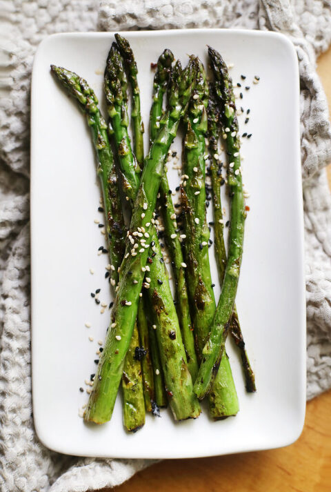 overhead shot of asparagus on a white platter