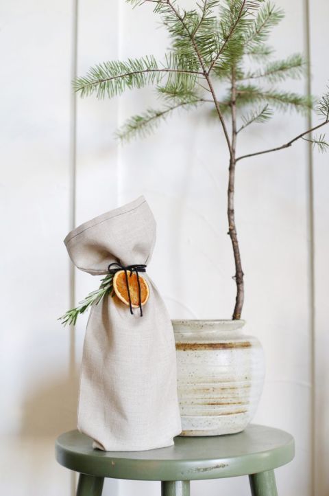 linen wine bag tied with orange and herbs