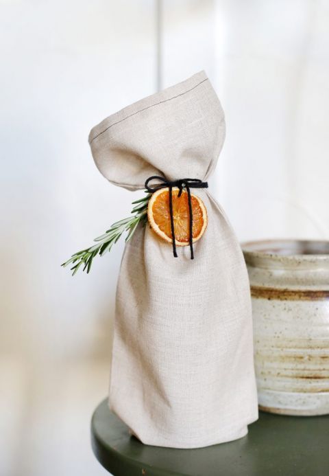 linen wine bag tied with orange and herbs