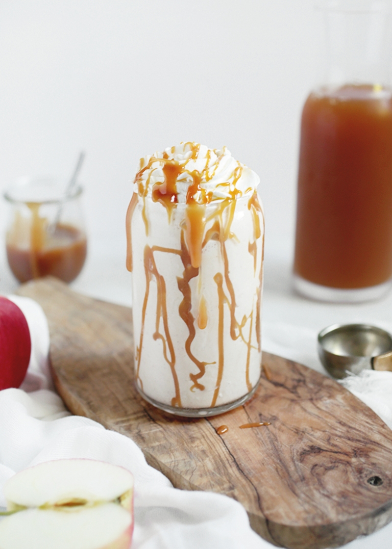 white milkshake in a glass with caramel drizzle