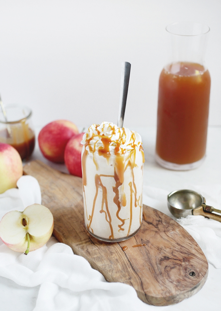 white milkshake in a glass with caramel drizzle