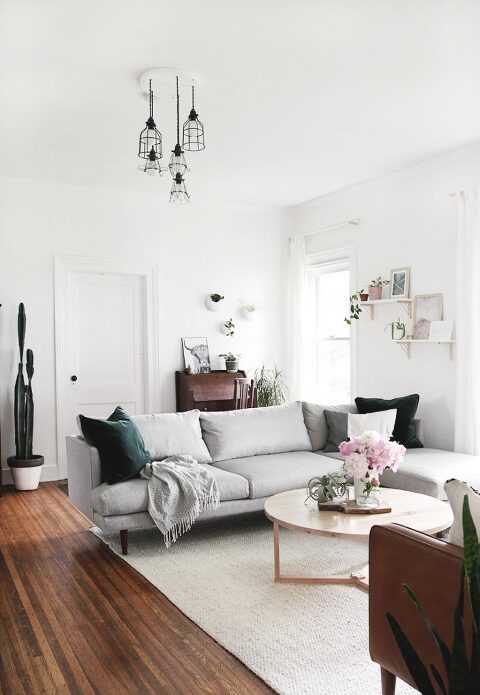 gray sectional couch with round coffee table