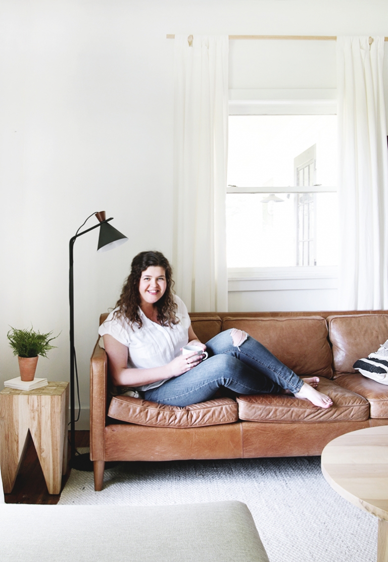 woman sitting on leather couch