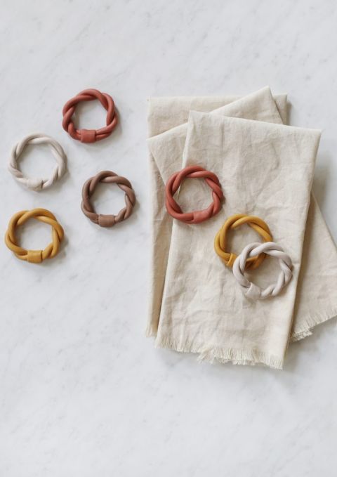 napkin rings on top of stack of fabric napkins