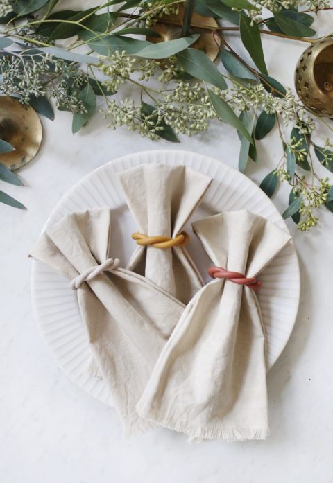 three napkins in napkin rings on a plate