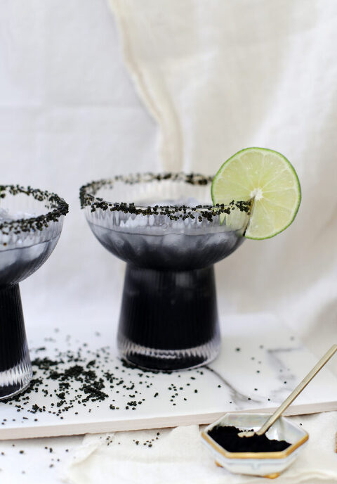 cocktail glass with black sugar rim and black cocktail