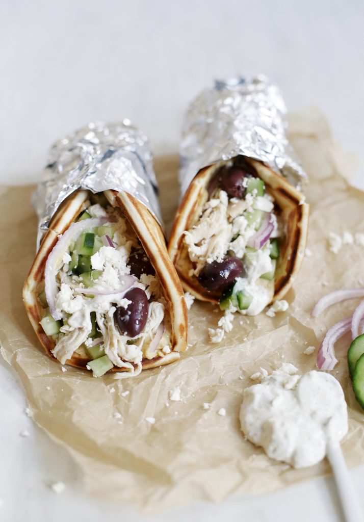 two chicken gyros on parchment paper