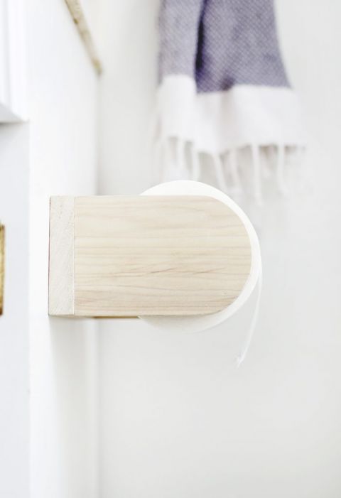 close up of wooden toilet paper holder