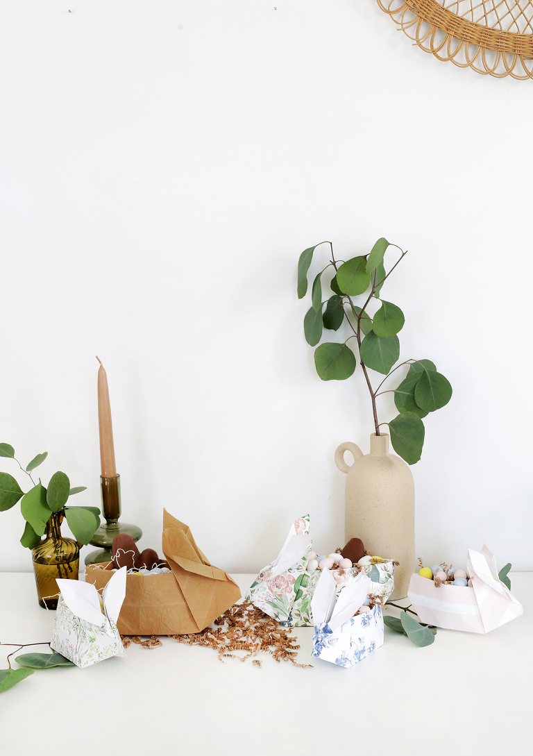 bunny shaped easter basket in front of candles and green