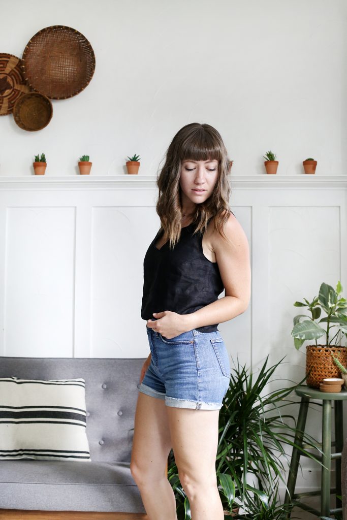 woman in black linen tank top and jean shorts