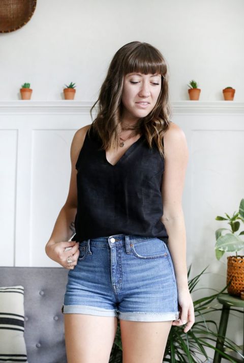 woman in black linen tank top and jean shorts