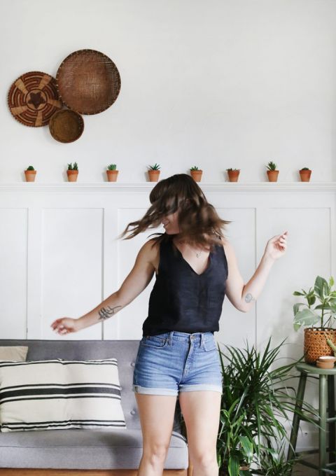 woman in black linen tank top and jean shorts