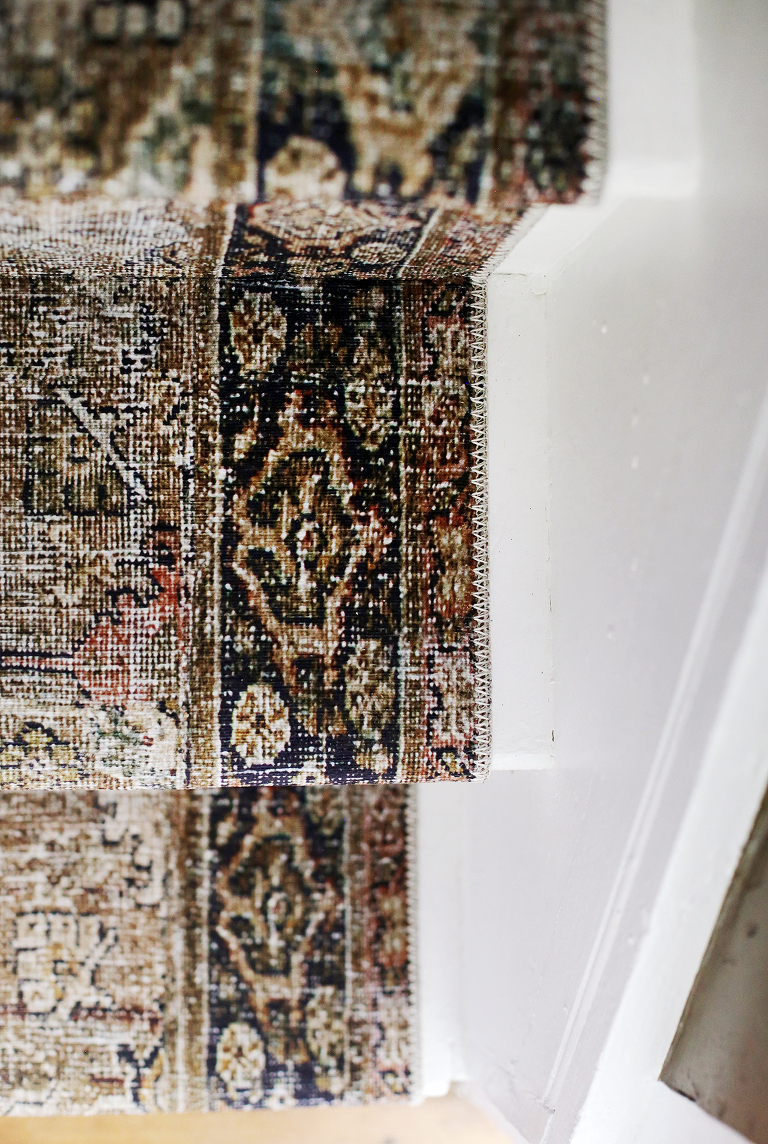 close up of vintage style runner on white stairs