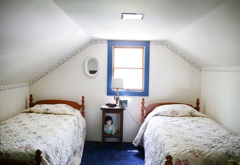 before image of twin beds in white and blue room