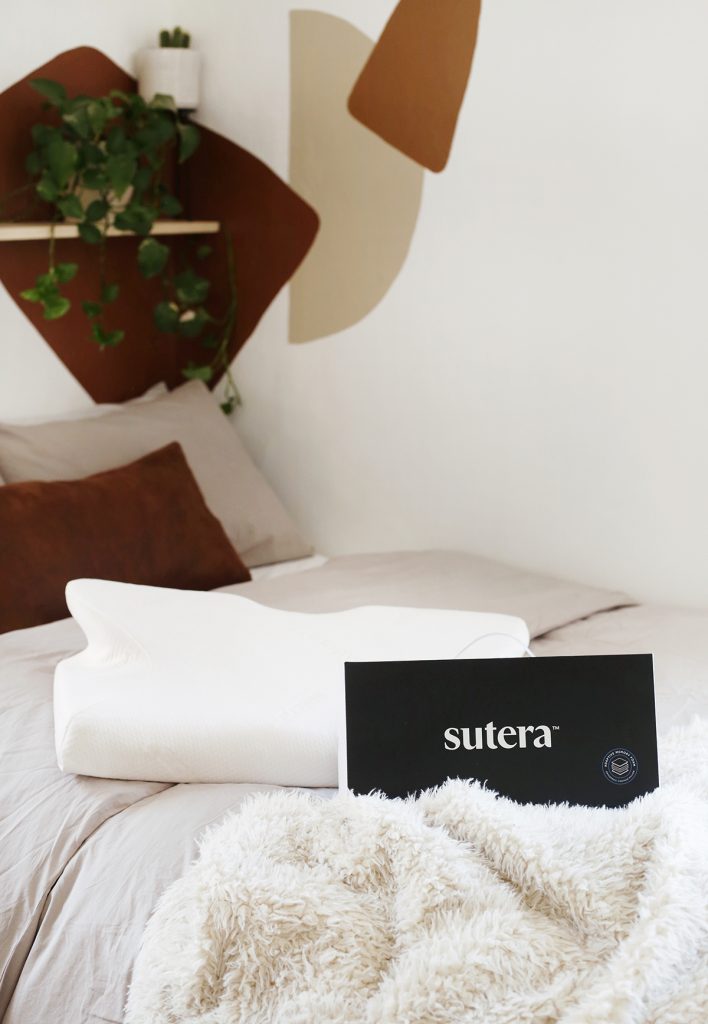 Sutera pillow and packaging on a bed