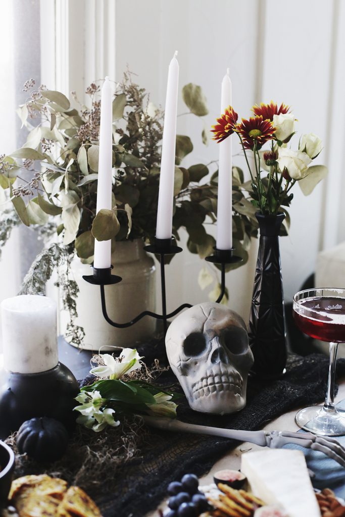 skull decor and candles with florals