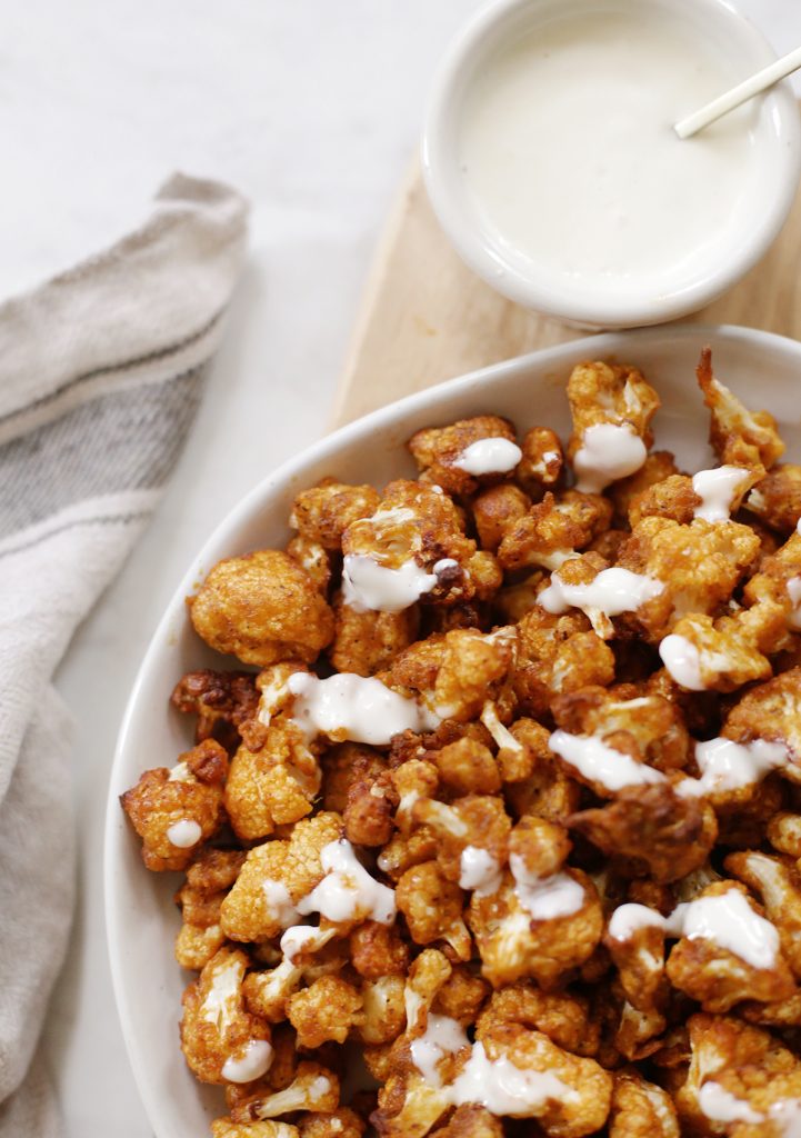 close up of buffalo cauliflower drizzled with blue cheese