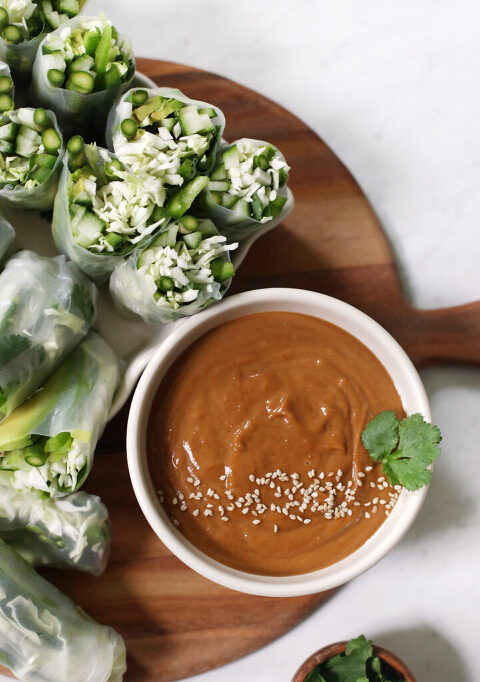 summer rolls on wearing workbench next to sauce