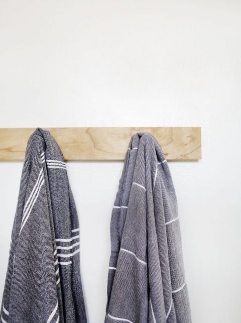 towels hanging on wooden peg rack