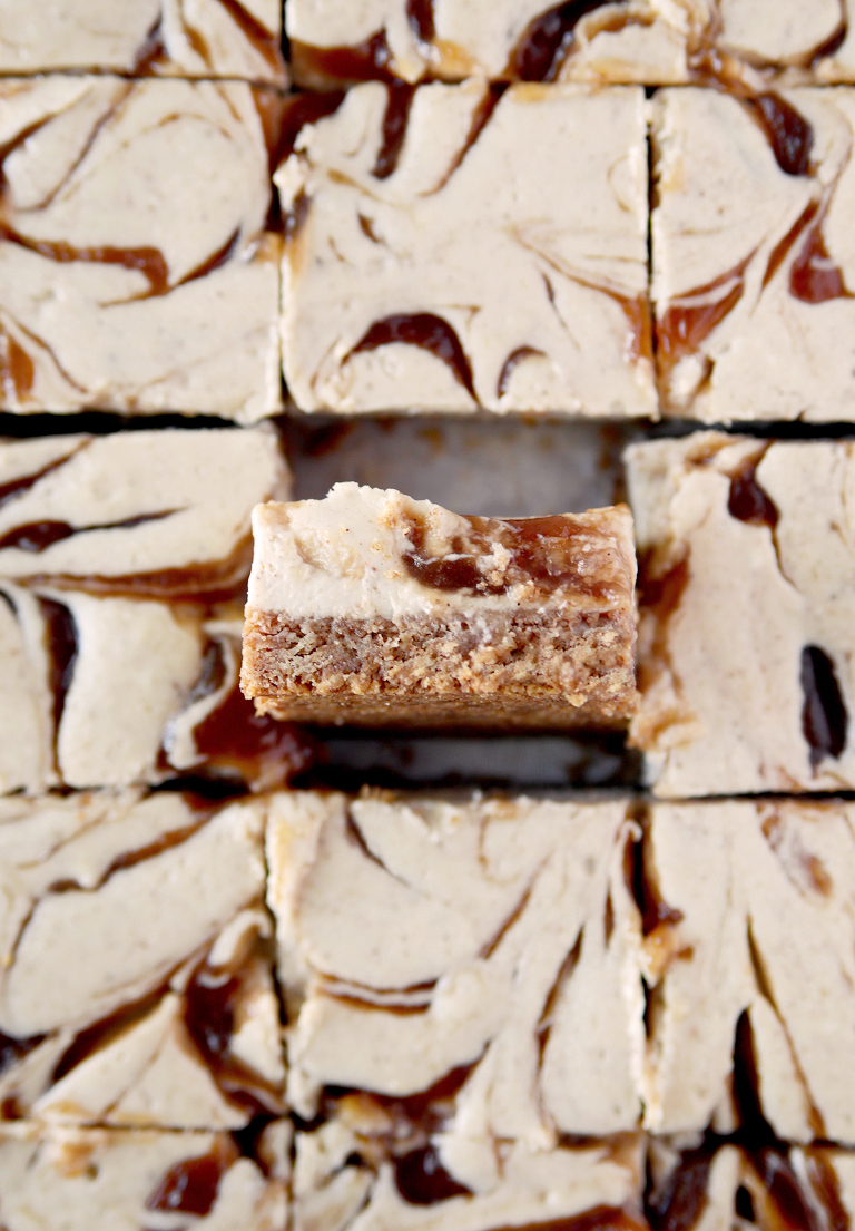 apple butter cheesecake bars cut into squares with one flipped onto its side