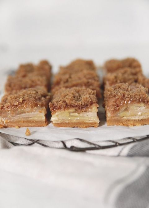 apple crisp bars side view sitting on parchment paper