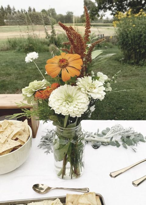 vase of neutral flowers on table outdoors