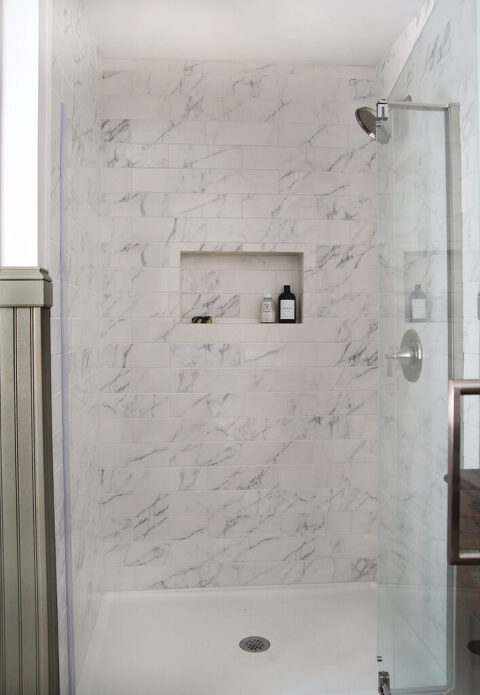 marble tile shower with glass door