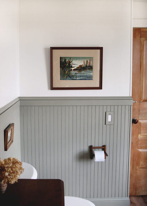 painted beadboard half wall with painting above it