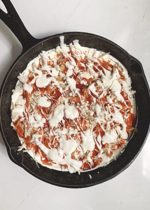 cast iron skillet with buffalo chicken dip in it