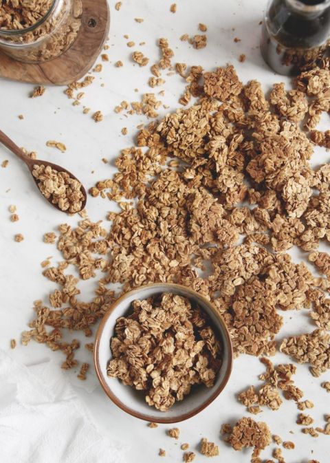 bowl of granola with spilled granola all around it