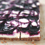 close up side view of woebegone raspberry cheesecake bars on nilla wafer crust