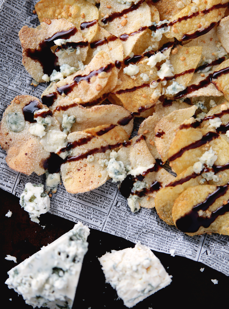 overhead shot of chips with cheese and glaze drizzled on top with blue cheese wedge in corner