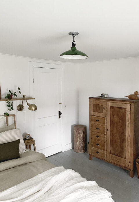 bedroom with white walls and old green pendant ceiling light