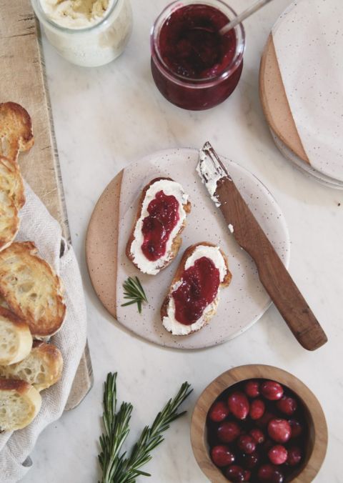 small plate with crostini appetizer and wood knife on it