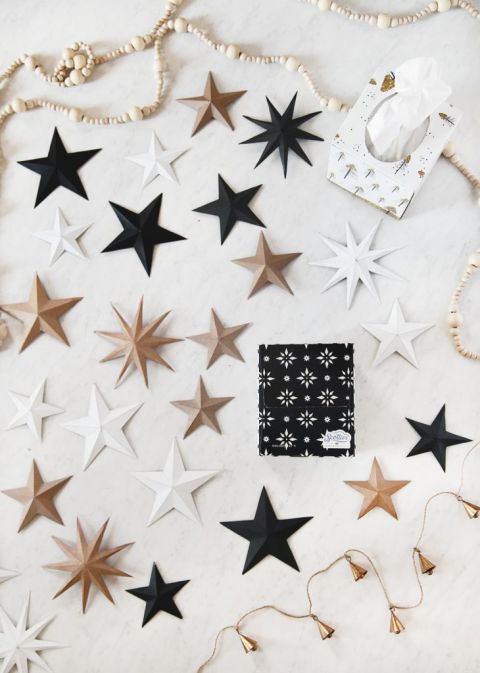 black, white, and natural 3D cardboard stars next to tissue boxes