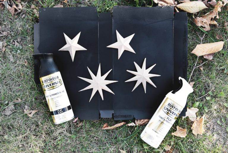 cardboard stars on black box with spray paint cans