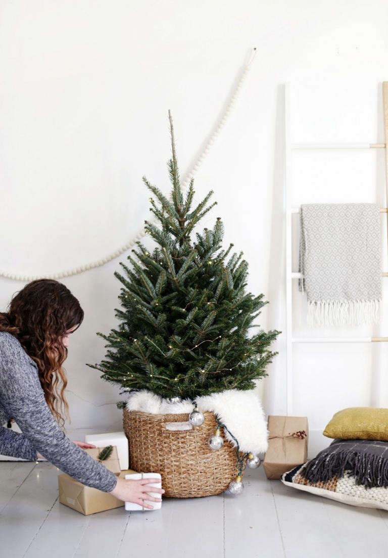 slim christmas tree in basket