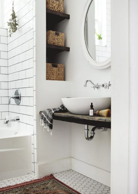 bathroom with tile floor and shower with white vessel sink