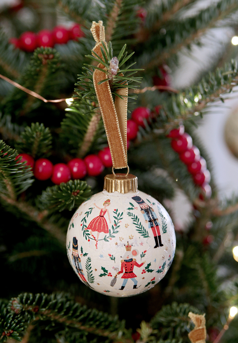 nutcracker decoupage ornament hanging on christmas tree branch
