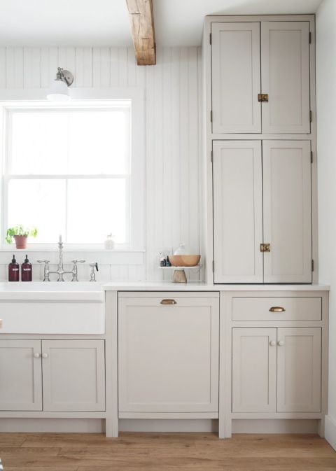 beige kitchen cabinets with counter to ceiling cabinet with diy panel dishwasher in lower cabinets