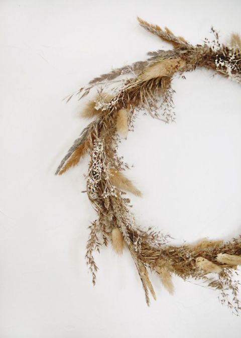 dried grass fall wreath on white wall